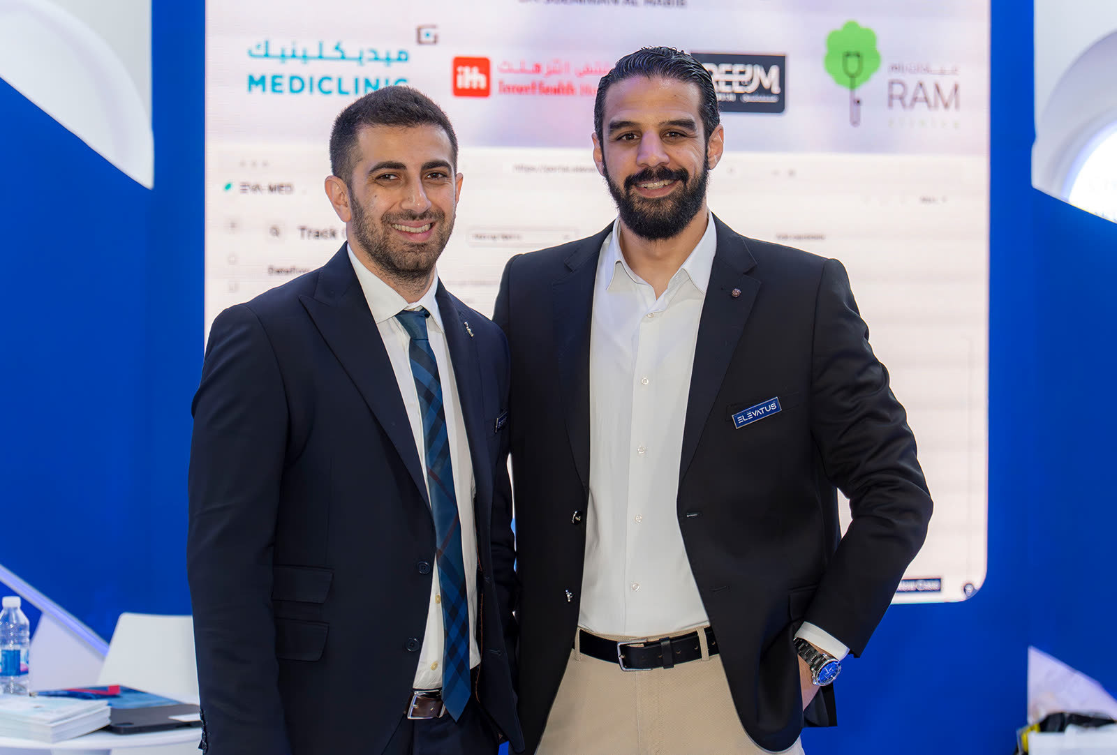 Two Elevatus colleagues talking at a company event