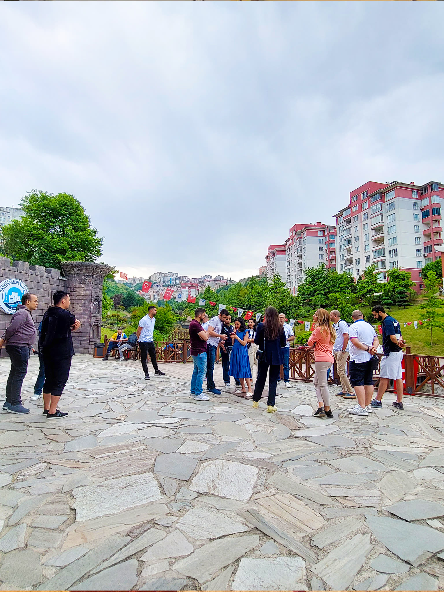 Elevatus team talking together on a stone terrace during a team trip
