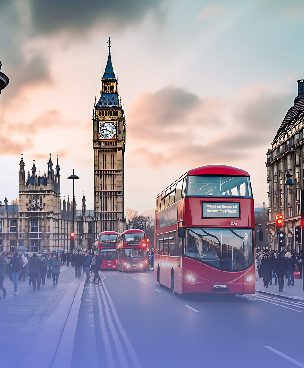 Westminster clock tower and red buses in London, United Kingdom