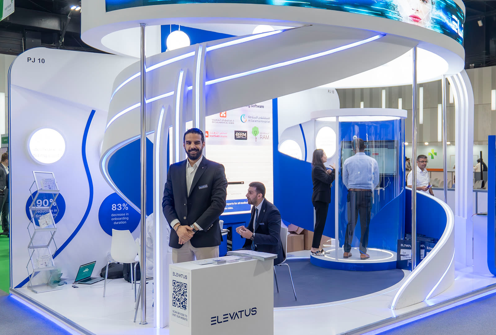 An Elevatus colleague welcoming visitors at the company exhibition stand